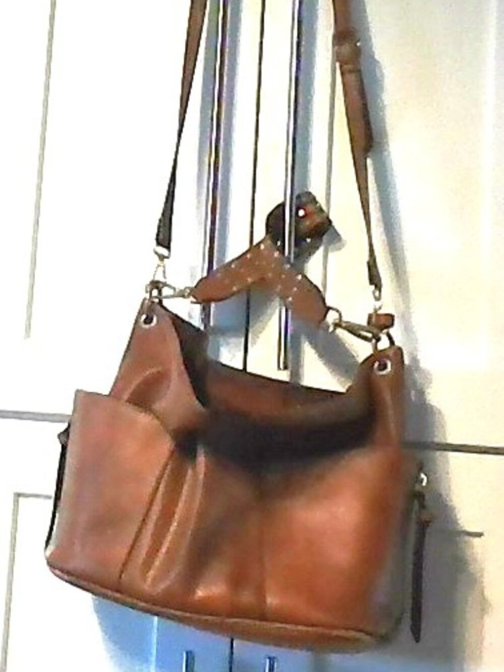 Variety of purses, backpacks, wallets and hats.
